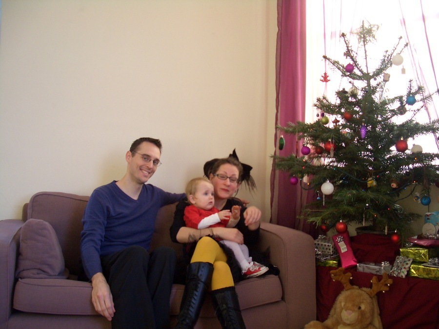 Jamie, Tyler, and Pascale next to the tree