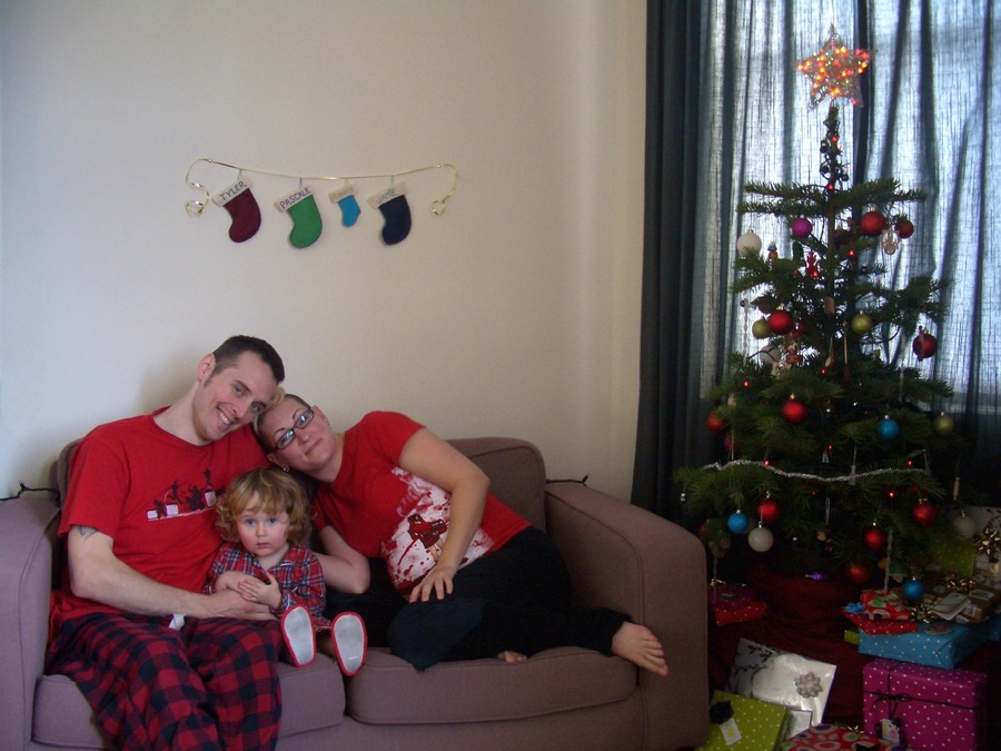 Jamie, Tyler, and Pascale next to the tree