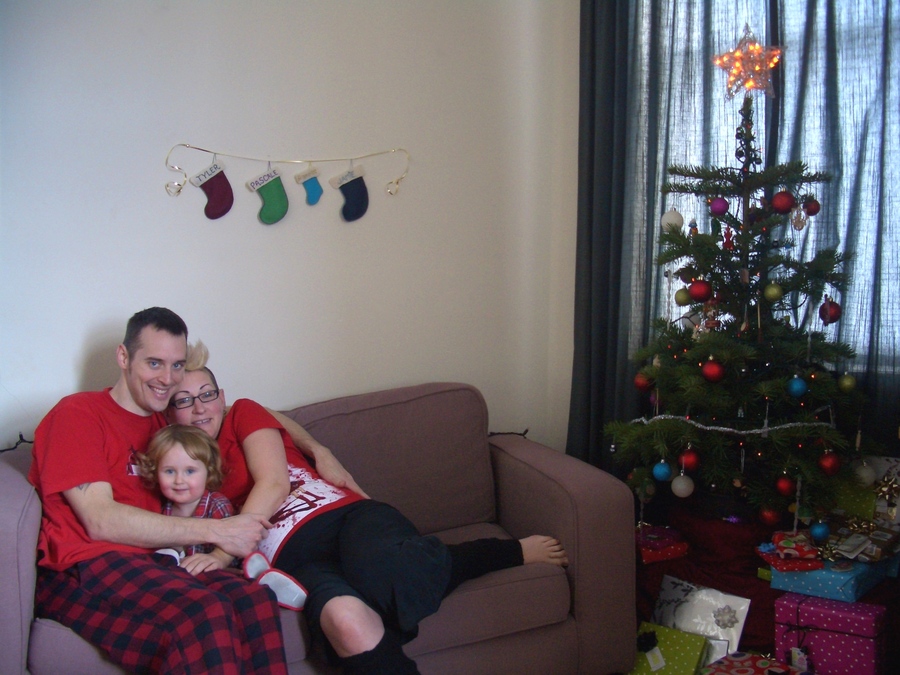 Jamie, Tyler, and Pascale next to the tree